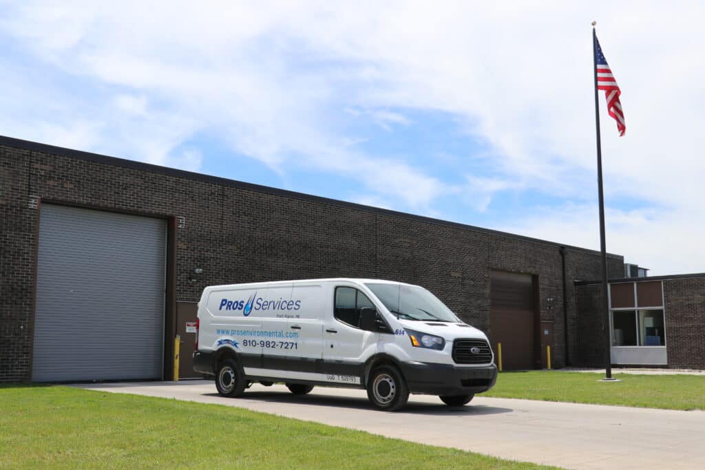 PROS Services emergency spill response truck equipped with vacuum tanks and hoses, ready for rapid containment and cleanup of oil, fuel, and hazardous chemical spills.