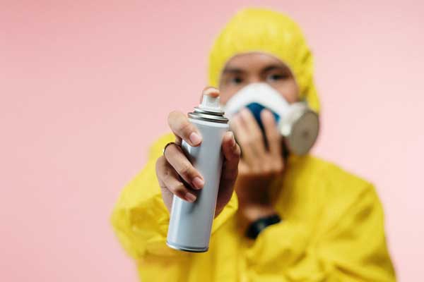 man holding a spray bottle for industrial cleaning 