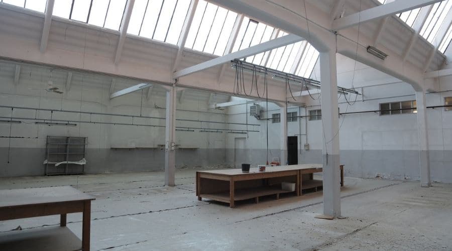 What is Factory decommissioning? | Modern interior of spacious empty warehouse