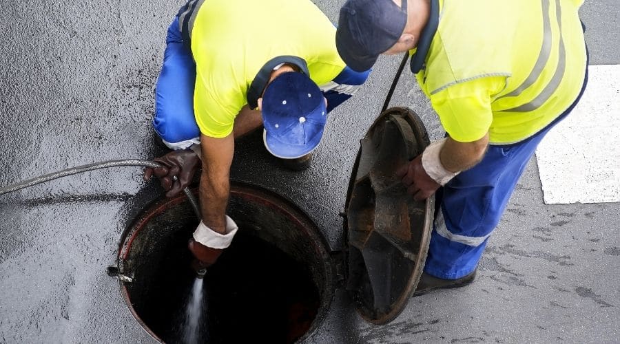 Sewer Cleaning Company | sewerage workers draining the sewer line