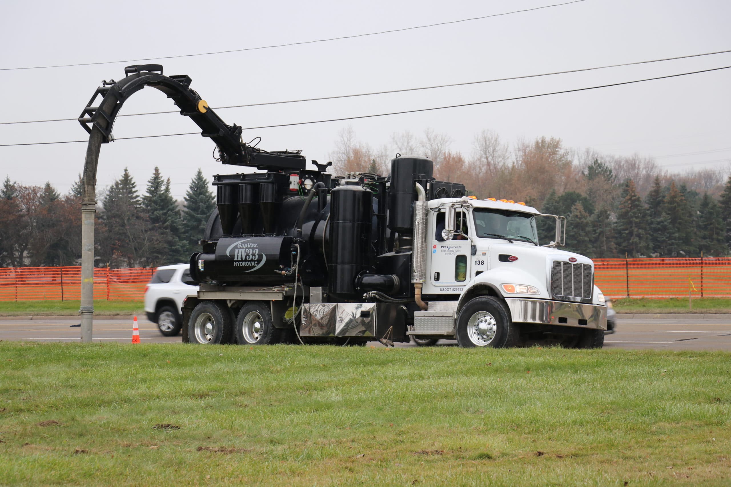Hydro excavation truck in operation on a Detroit field, showcasing precise and environmentally-friendly excavation method.